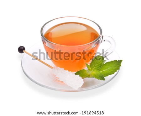 Cup of tea with mint and sugar stick isolated on white