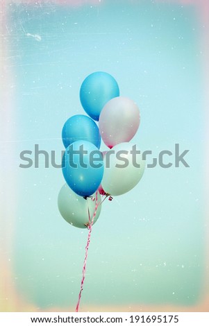 Grunge image of blue, pink and white balloons