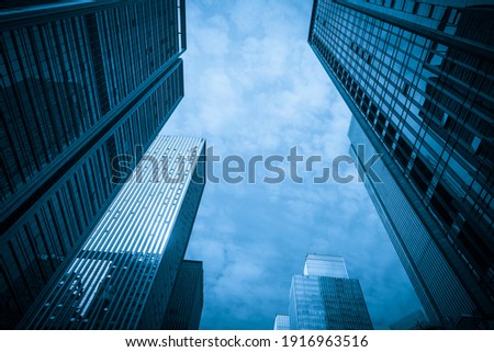Looking Up Blue Modern Office Building Royalty-Free Stock Photo #1916963516