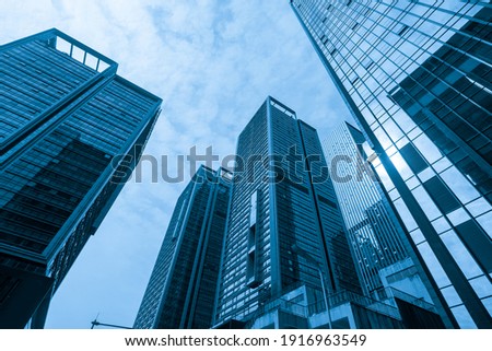 Looking Up Blue Modern Office Building Royalty-Free Stock Photo #1916963549