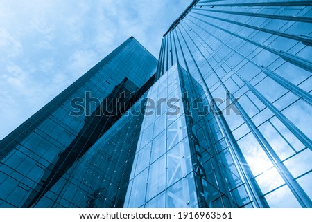 Looking Up Blue Modern Office Building Royalty-Free Stock Photo #1916963561