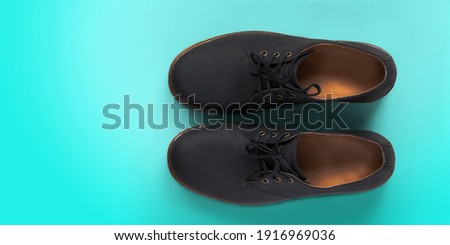 men's footwear. Top view of pair of plain shoe on green background mock up. New shoes concept.