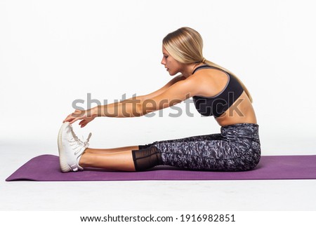 young brunette woman doing stretches