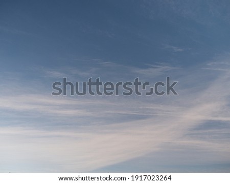 Cirrostratus also known as veil clouds in winter with a slight spotlight Royalty-Free Stock Photo #1917023264