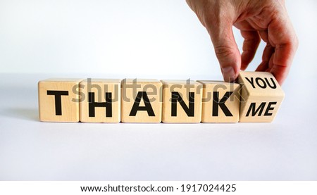 Thank you or me symbol. Businessman turns a cube and changes words 'thank me' to 'thank you'. Beautiful white background, copy space. Business, psychology and thank you or me concept.