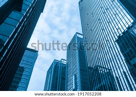 Looking Up Blue Modern Office Building Royalty-Free Stock Photo #1917052208