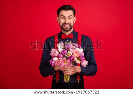 Photo of young happy cheerful handsome gentleman hold bouquet celebrate woman day isolated on red color background