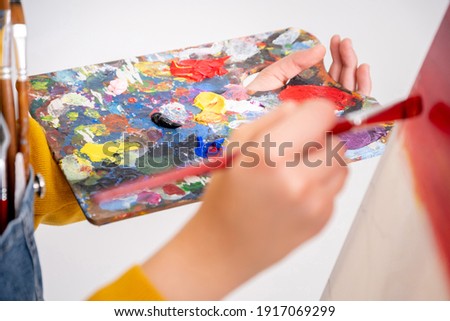artist painting in workshop, white background