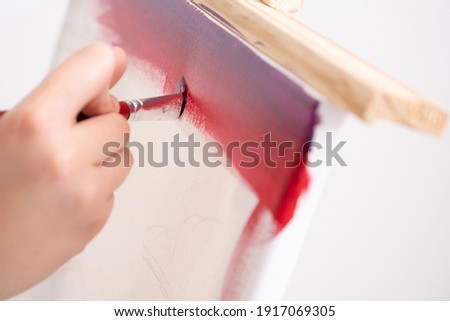 artist painting in workshop, white background