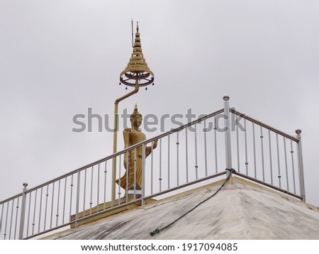 Buddha statue on building on blue sky background 