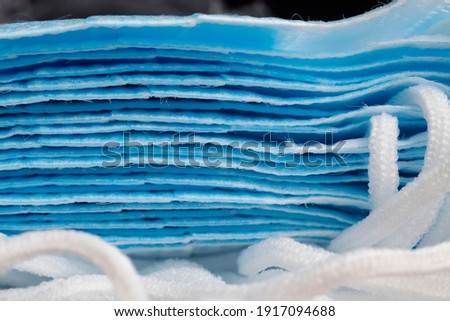 Folded surgical masks made of Polyester fiber with ties sideways closeup
