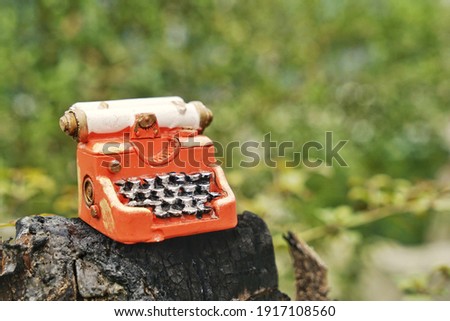 Hand home made model. Steampunk style future Typewriter on nature background.