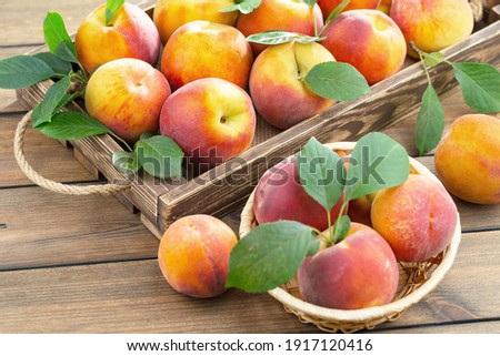 Ripe peaches on an old background Royalty-Free Stock Photo #1917120416