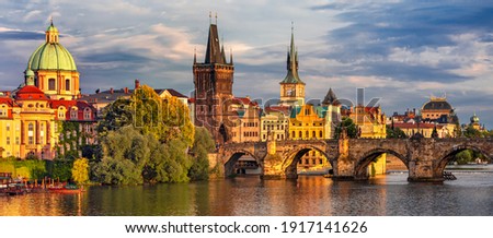 Prague - colorful sunset view on old town, Charles bridge and Vltava river, Czech Republic  