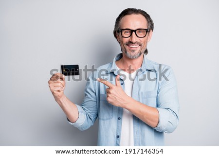 Photo of handsome man happy smile point finger credit card advice choice ad select suggest isolated over grey color background
