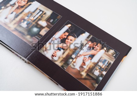 the pages of the photobook from photo shoots of a a beautiful happy couple in a retro country house. grainy paper texture. photo design in the album. Memory. Designer. black background 