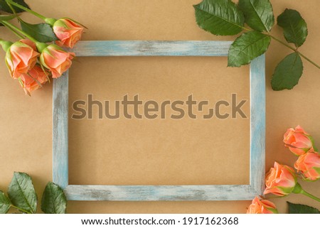 old photo frame with bunch of orange roses.