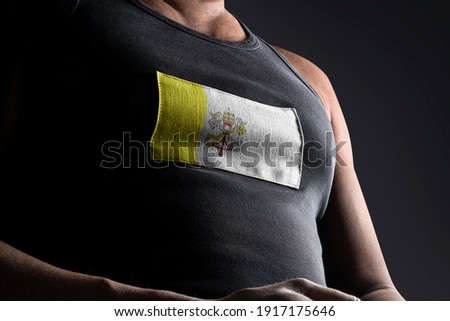 The national flag of Vatican on the athlete's chest