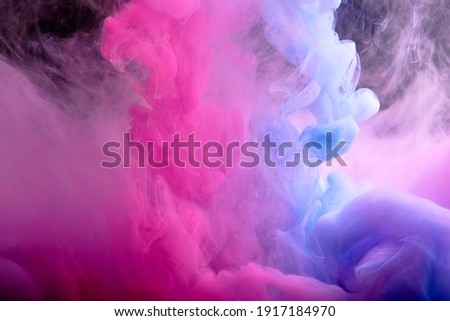 Abstract pink and blue background. Paint movement in water.