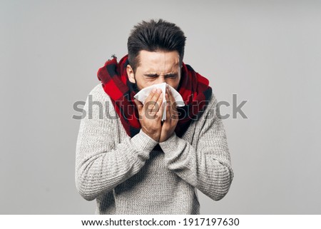 man wearing plaid scarf cold handkerchief health problems Royalty-Free Stock Photo #1917197630