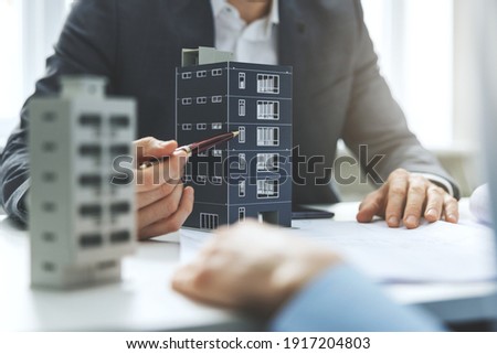 real estate developer and architect discussing new housing development project in office Royalty-Free Stock Photo #1917204803
