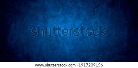 Dark and blue  abstract cement wall and studio room interior texture for display products wall background.	