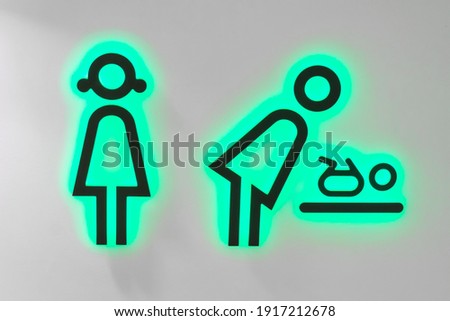 Baby room toilet, changing icon with neon green illuminated