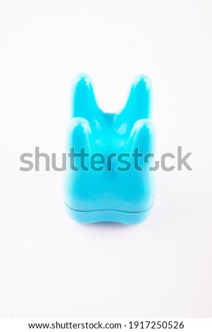 plastic toy tooth on white background