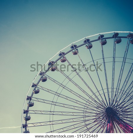 Retro Vintage Style Photo Of A Ferris Wheel At An Amusement Park At Dusk