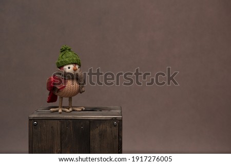 Knitted robin perched on a wooden box. Ideal to use for adding text to a slide for stencils
