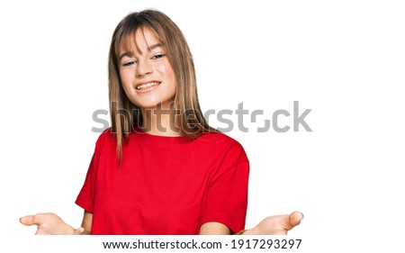 Teenager caucasian girl wearing casual red t shirt smiling cheerful offering hands giving assistance and acceptance. 