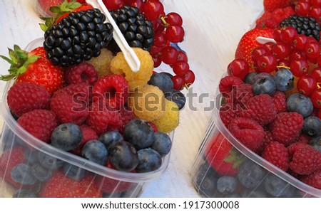          Mix of berries in transparent containers                      