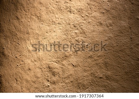 Wall of home made from mud and light. Clay wall texture of House structure. Soil building for background. soft picture. Selective focus