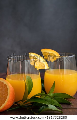 Freshly squeezed orange juice on wooden background
