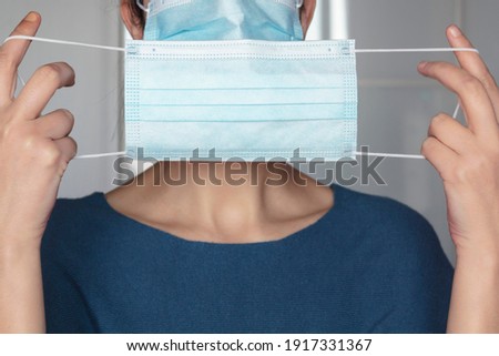 Woman putting a second protective face mask