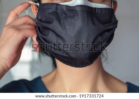 Woman wearing double face masks at the same time