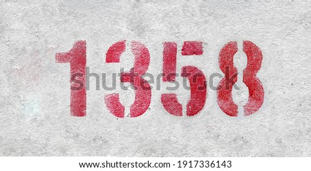Red Number 1358 on the white wall. Spray paint.