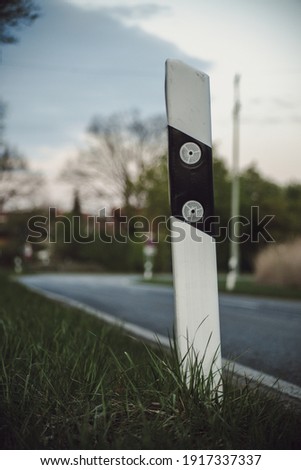 reflector post next to a rural raod