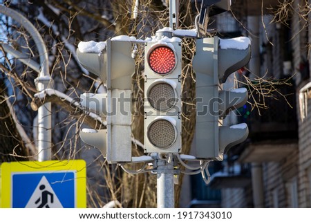 traffic lights with a red traffic signal on the street of the city. High quality photo