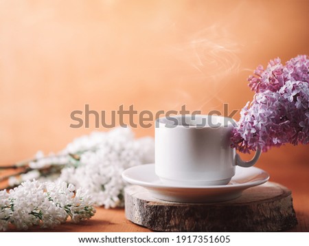 Spring breakfast, good morning with a cup of hot coffee on the wooden, blooming lilac branches
