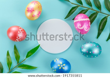 Minimal easter card. Five easter trendy color decorated eggs on light blue background. Round copy space for text.