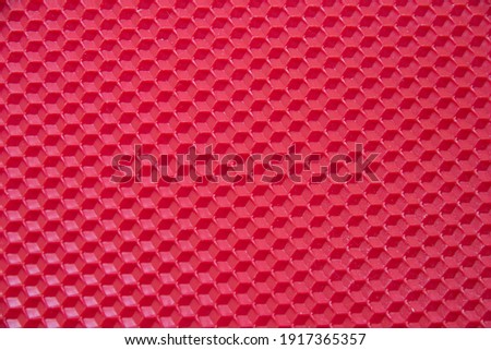Red beeswax for candle, texture. Honeycomb background from a bee hive. 