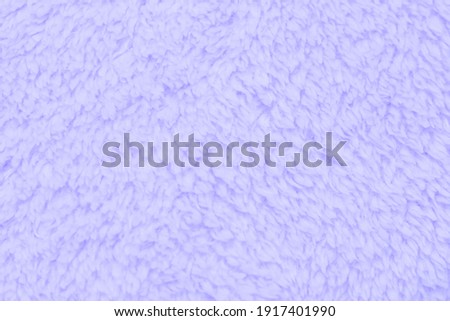 Background picture of a soft fur ิblue sky carpet. wool sheep fleece closeup texture background. Fake color beige fur fabric. top view.
