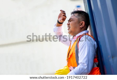 Factory worker man working in hot weather and he look tired from work. Royalty-Free Stock Photo #1917402722
