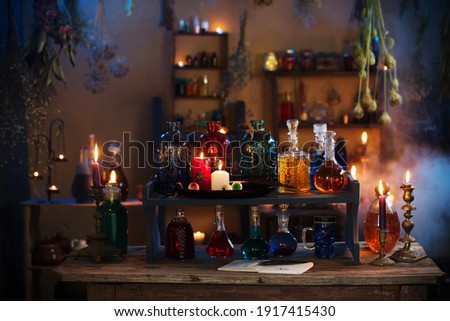magic potions in  witch's house with burning candles at night Royalty-Free Stock Photo #1917415430