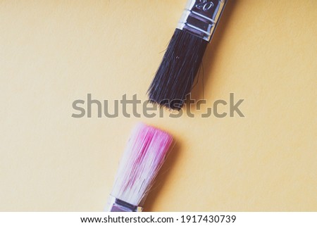 red and black brush on a yellow background, selective focus, design blank, text space, toned image