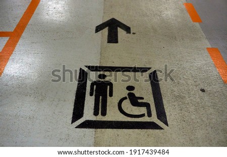 Directional sign on the ground to follow a wheelchair 