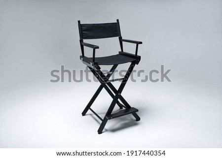 chair. soft chair. director's chair. sofa. photo studio equipment. White cyclorama.                      Royalty-Free Stock Photo #1917440354