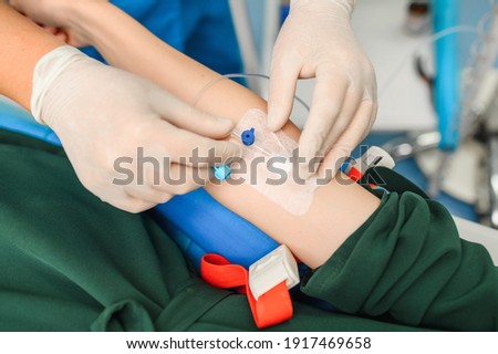 Placing a catheter for a patient to administer drugs Royalty-Free Stock Photo #1917469658