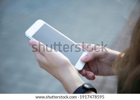 Cropped shot view of woman's hands holding smart phone